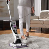 Woman vacuuming with shark vacuum cleaner